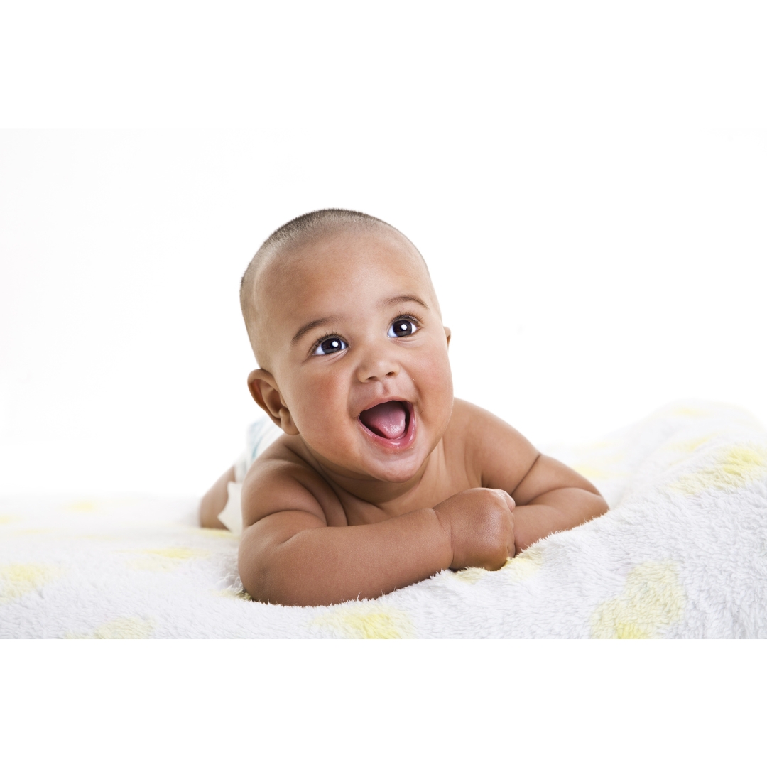 Infant laying on stomach on a blanket