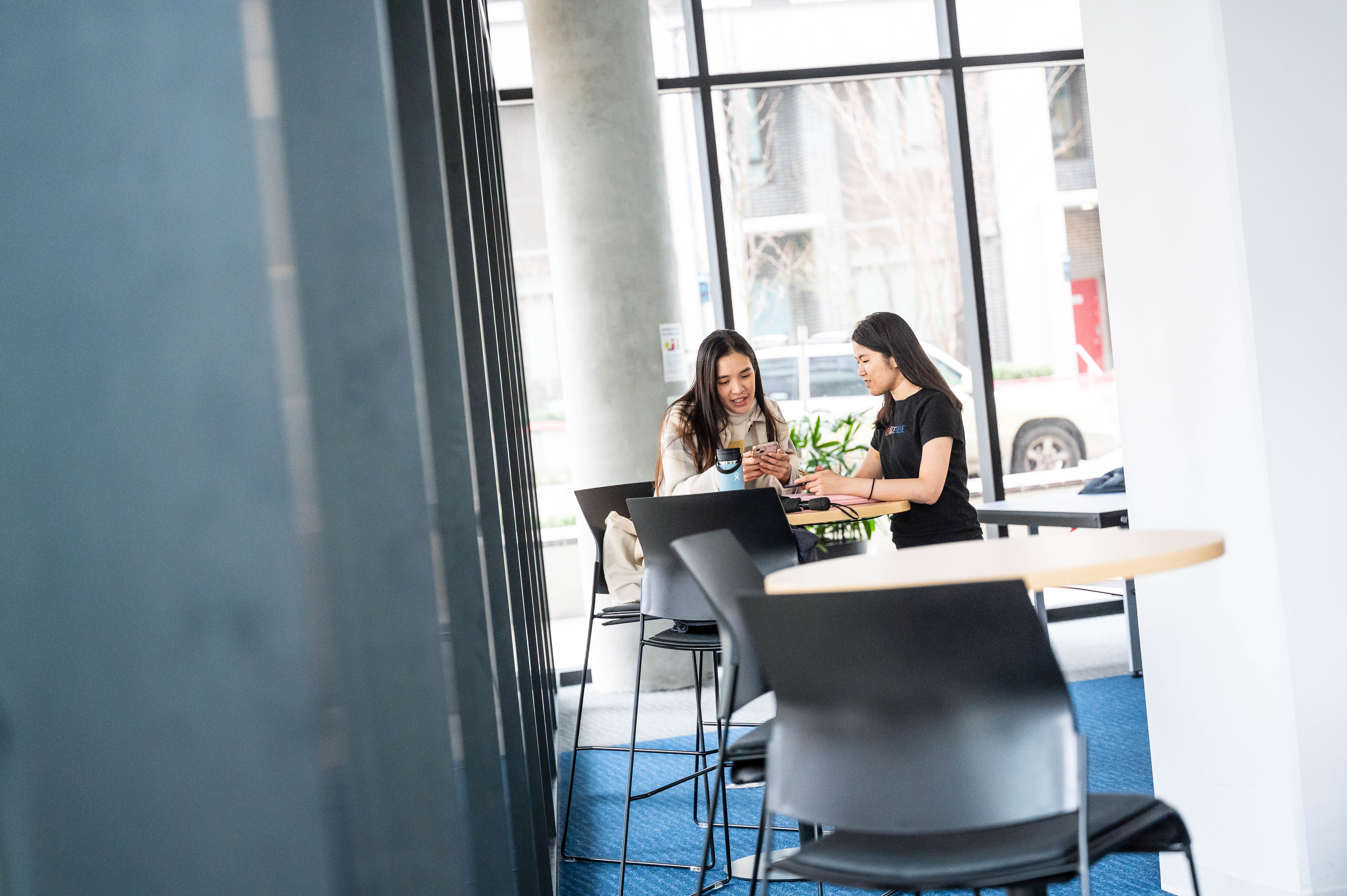 Two people at table talking