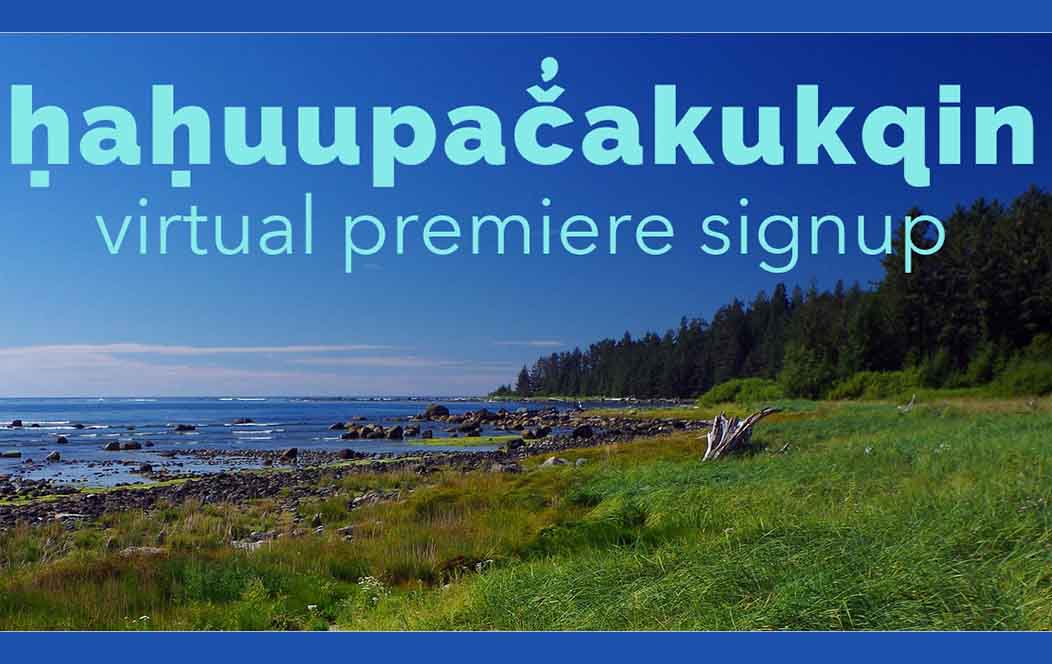 An image of a seashore with green grass dotted with rocks running to the sea