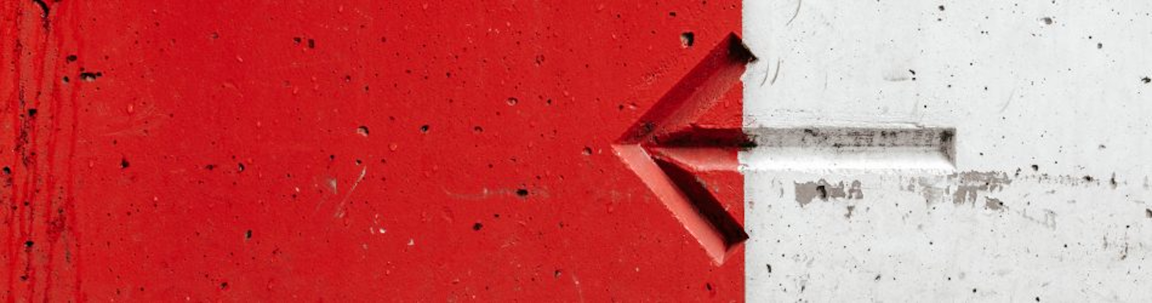 A picture of an arrow pointing left, on a red and white background