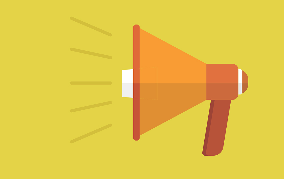 A picture of an orange megaphone against a yellow background.