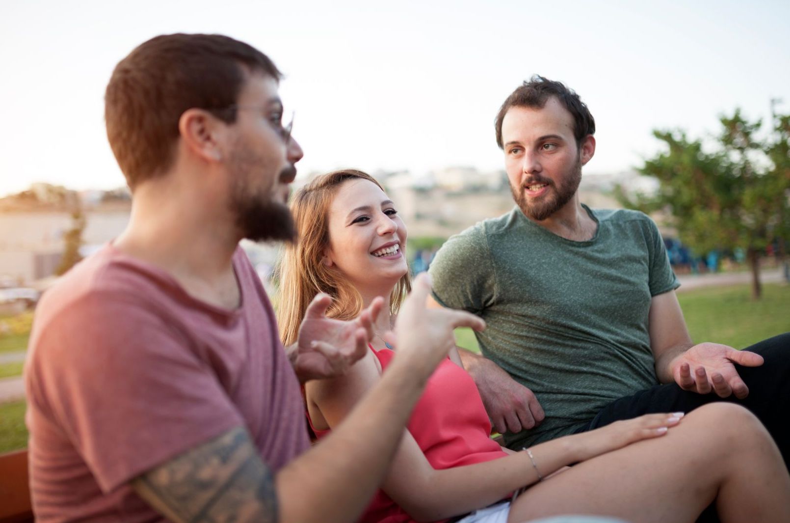 Three people outside having a lively conversation