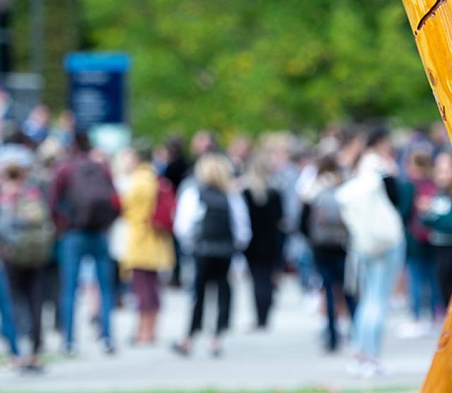 Blurred people in background, welcome post.