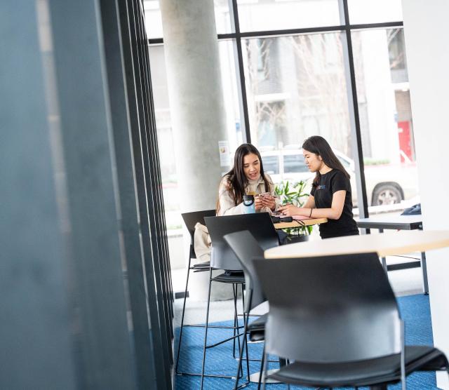 Two people at table talking