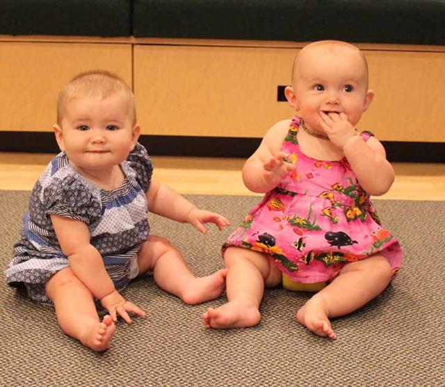 This picture of two babies is used to illustrate the story, which details research suggesting that at an early age, infants are attending to and learning from their environment. 