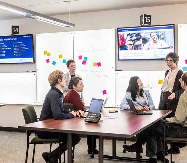 A picture of the SSHRC Partnership Grant group looking at Janet Werker