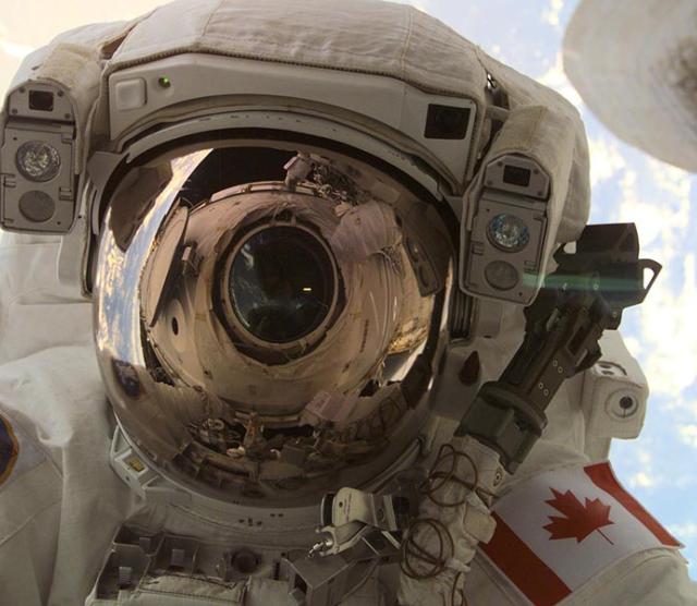 A through-the-window view of astronaut Chris A. Hadfield, STS-100 mission specialist representing the Canadian Space Agency, taken during the first extravehicular activity of the STS-100 mission.