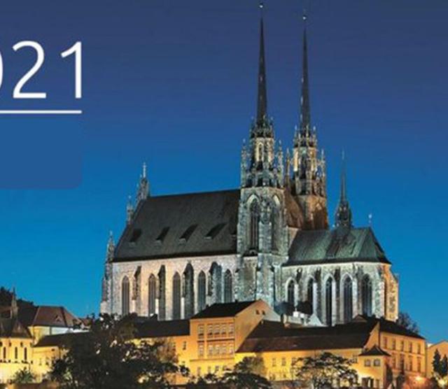 An image of a church in the Czech Republic standing on a hill against the blue night sky