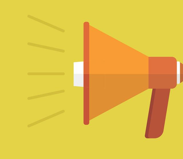 A picture of an orange megaphone against a yellow background.