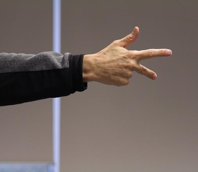 A close up of Nigel Howards hand extended in an ASL sign