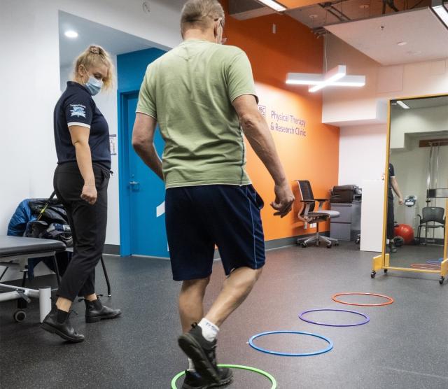 Physical Therapy student helping client with exercises.