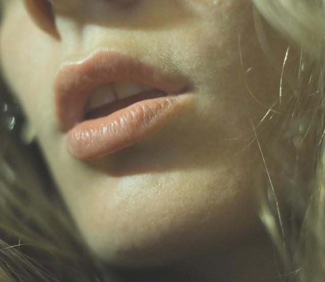 A close up on a woman's mouth and cheeks
