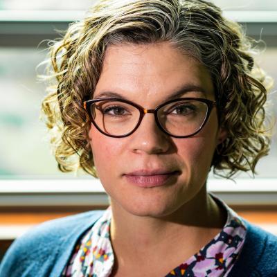 A headshot of Dr. Along Fyshe, wearing glasses and sitting in front of a window