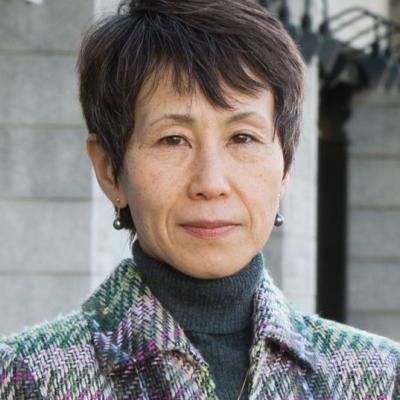 A headshot of Ryuko Kubota standing outside