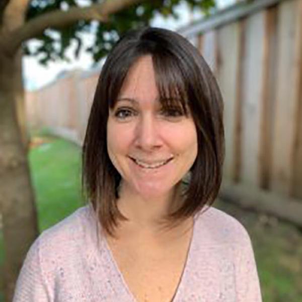 A headshot of Alexis Black standing outside