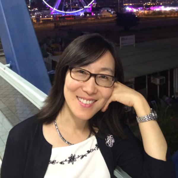A headshot of Sylvia Chan with her head propped against her hand