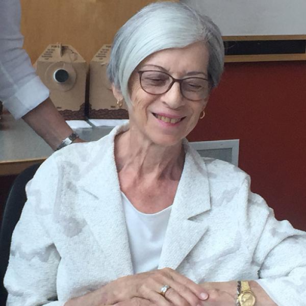 A picture of Marietta Hurst smiling and looking down at the ground