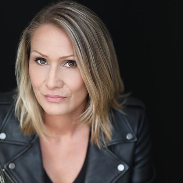 A headshot of Jules Koostachin with a black background