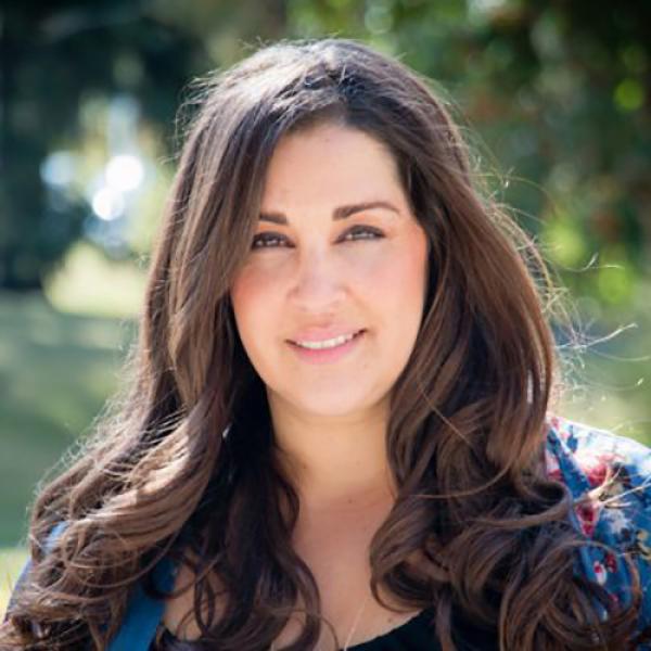 A headshot of Dr. Anusha Kassan standing outside