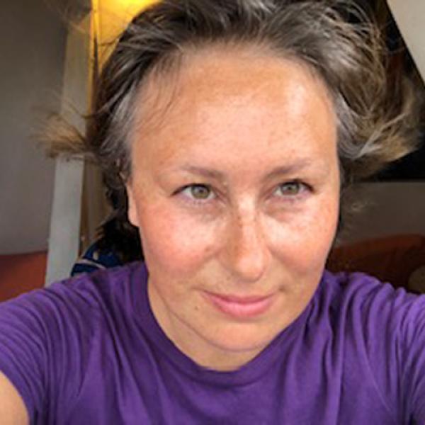 A headshot of Caroline Lebrec wearing a purple shirt