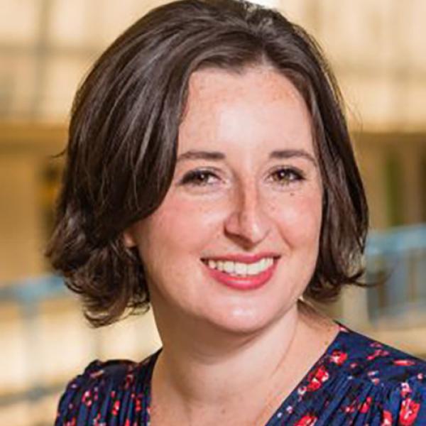 A headshot of Lillian May standing inside the UBC Psychology building