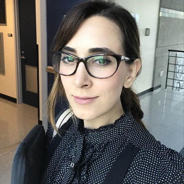 A headshot of Dr. Negin Motamed-Yeganeh wearing glasses and a black shirt